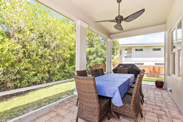 view of patio featuring a ceiling fan, outdoor dining space, and fence