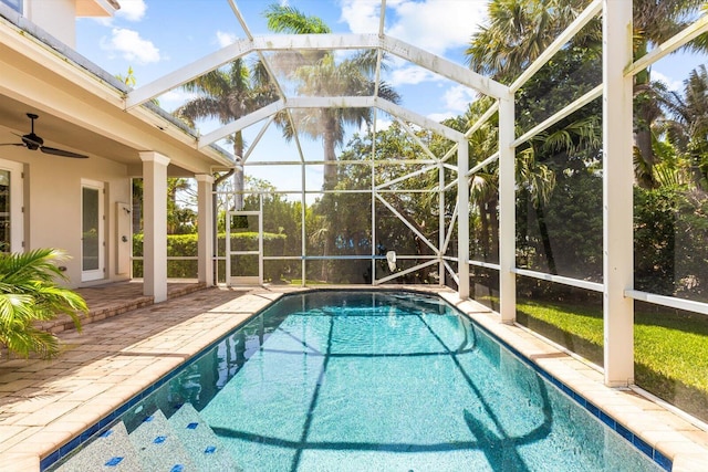 outdoor pool featuring a lanai, a ceiling fan, and a patio area