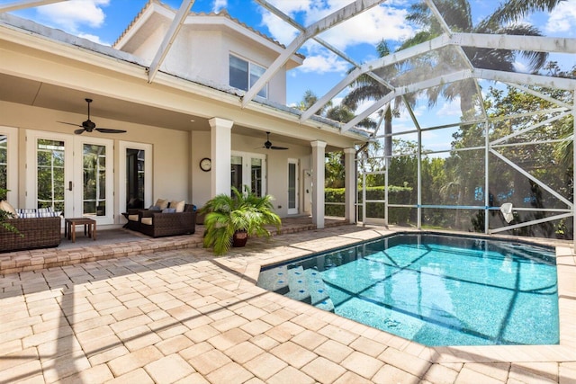 pool with a patio area, an outdoor living space, a ceiling fan, a lanai, and french doors