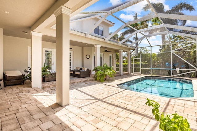 pool with outdoor lounge area, a patio, a ceiling fan, and a lanai