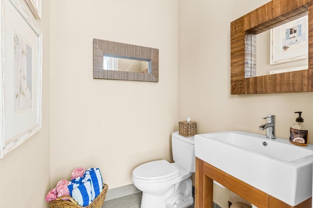 bathroom featuring toilet, tile patterned floors, and vanity
