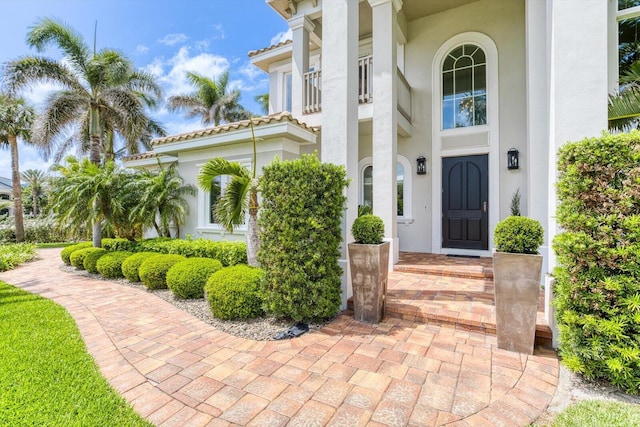 doorway to property featuring stucco siding
