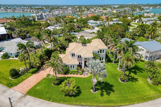 drone / aerial view featuring a residential view and a water view