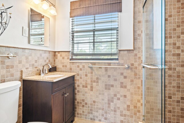 31 S Golfview Rd # 11, Lake Worth Beach, FL 33460 - bathroom featuring a wainscoted wall, toilet, a wealth of natural light, and a stall shower