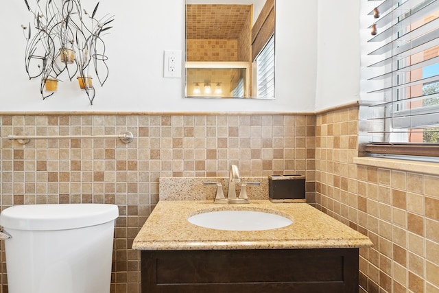 31 S Golfview Rd # 11, Lake Worth Beach, FL 33460 - bathroom featuring vanity, a wainscoted wall, toilet, and tile walls