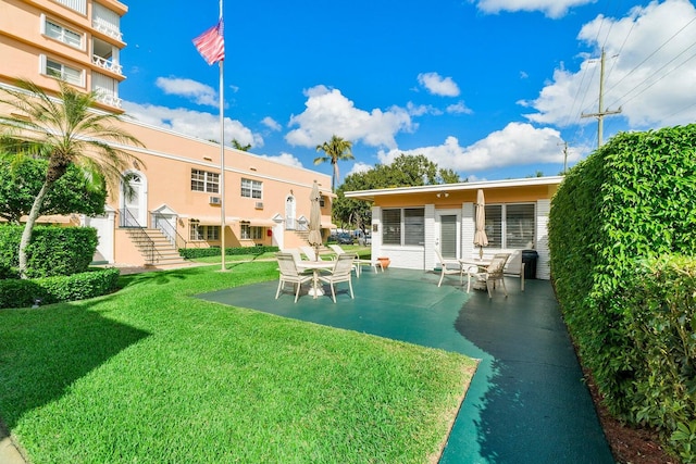31 S Golfview Rd # 11, Lake Worth Beach, FL 33460 - back of house with a lawn and a patio area