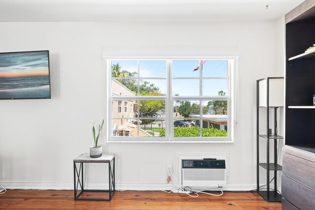 31 S Golfview Rd # 11, Lake Worth Beach, FL 33460 - interior space featuring an AC wall unit, plenty of natural light, and wood finished floors