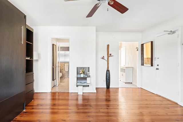 31 S Golfview Rd # 11, Lake Worth Beach, FL 33460 - unfurnished living room featuring baseboards, a ceiling fan, and light wood-style flooring