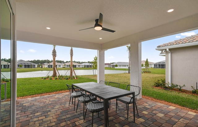 10822 Stellar Cir Unit Renown 26, Palm Beach Gardens, FL 33412 - view of patio / terrace with a water view, outdoor dining area, a residential view, and ceiling fan