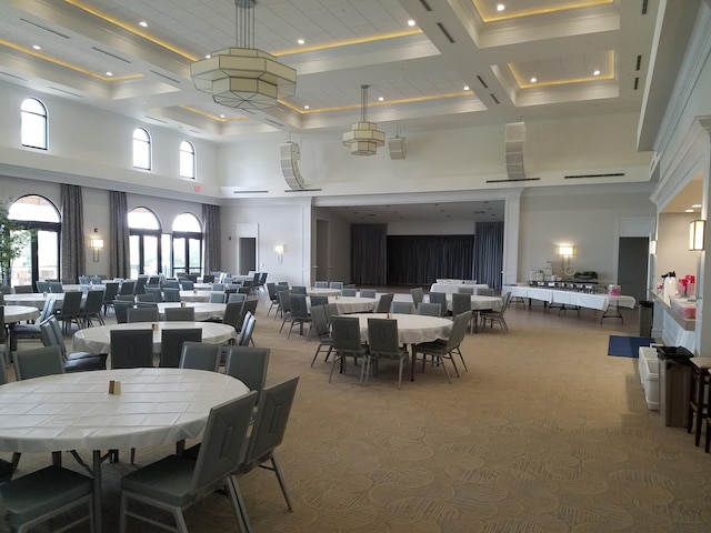 carpeted dining area featuring a towering ceiling, recessed lighting, and coffered ceiling