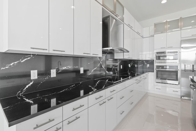 kitchen featuring modern cabinets, decorative backsplash, white cabinets, and wall chimney exhaust hood