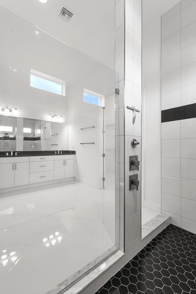 bathroom featuring walk in shower, visible vents, and vanity