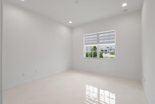 tiled spare room with baseboards and recessed lighting