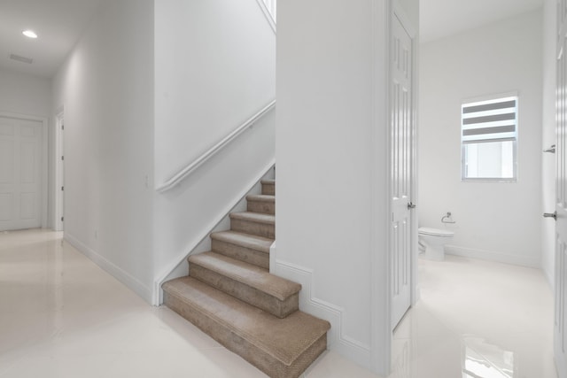 staircase featuring recessed lighting, tile patterned floors, and baseboards