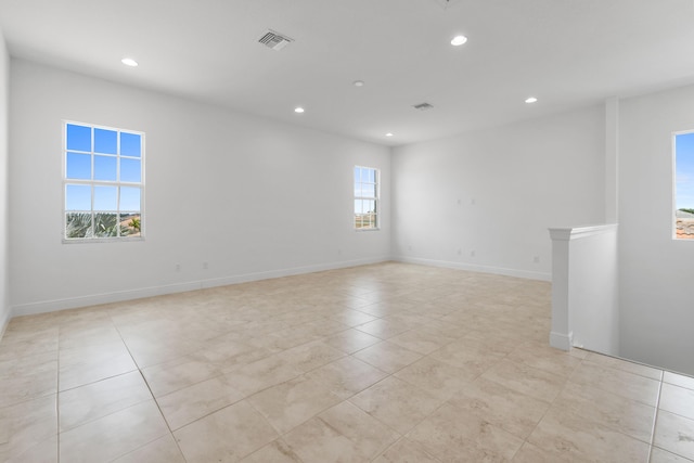 spare room featuring light tile patterned floors, recessed lighting, visible vents, and baseboards