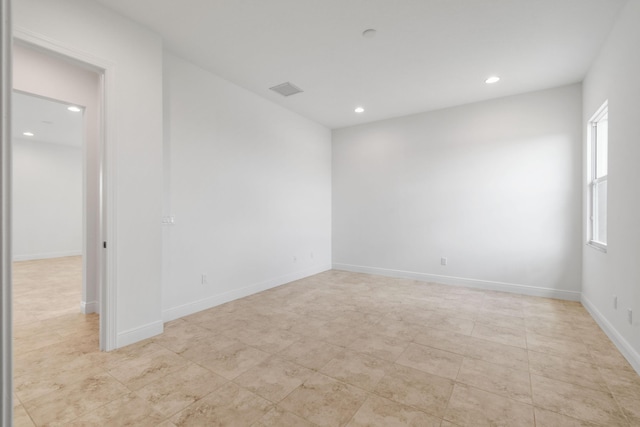 unfurnished room featuring recessed lighting, light tile patterned flooring, and baseboards