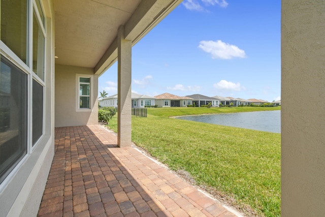 view of patio featuring a water view and a residential view