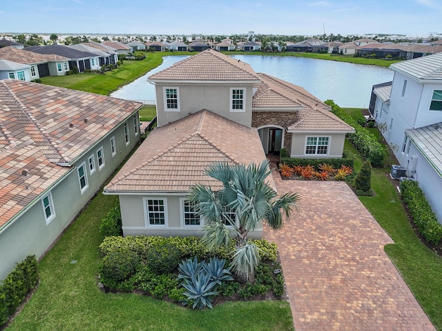 drone / aerial view with a residential view and a water view