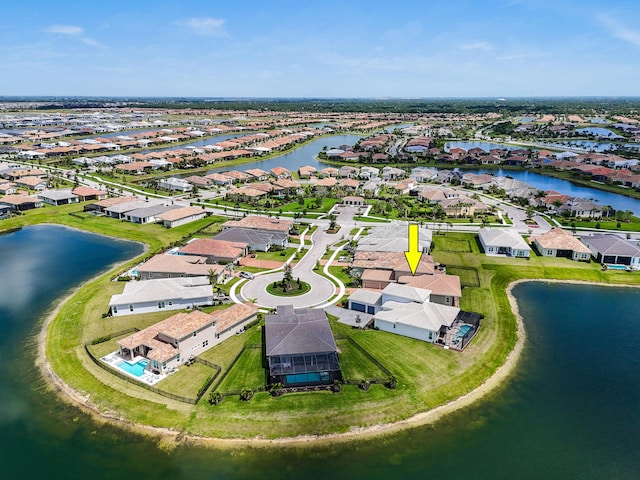 drone / aerial view featuring a residential view and a water view