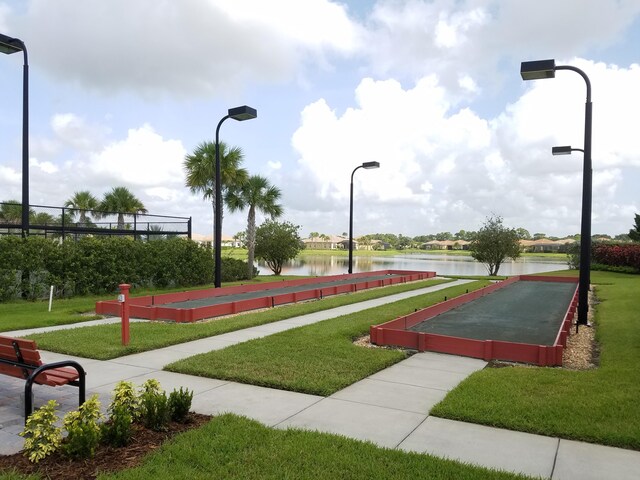 view of community featuring a water view and a yard
