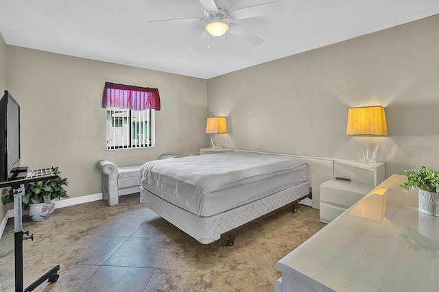 bedroom with baseboards and a ceiling fan