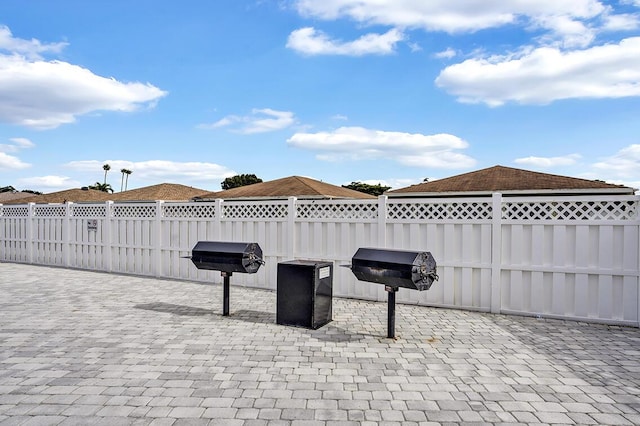 view of patio with grilling area and fence