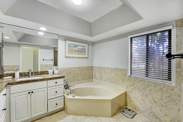 5337 Fountains Dr S, Lake Worth, FL 33467 - bathroom with tile walls, a bath, vanity, and a raised ceiling