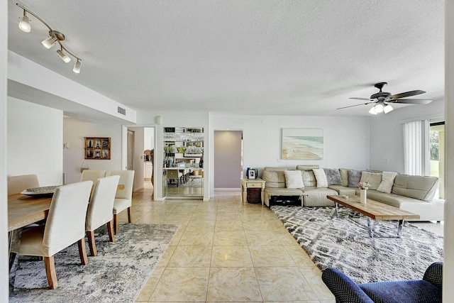 5337 Fountains Dr S, Lake Worth, FL 33467 - living room with a ceiling fan, a textured ceiling, visible vents, and light tile patterned floors