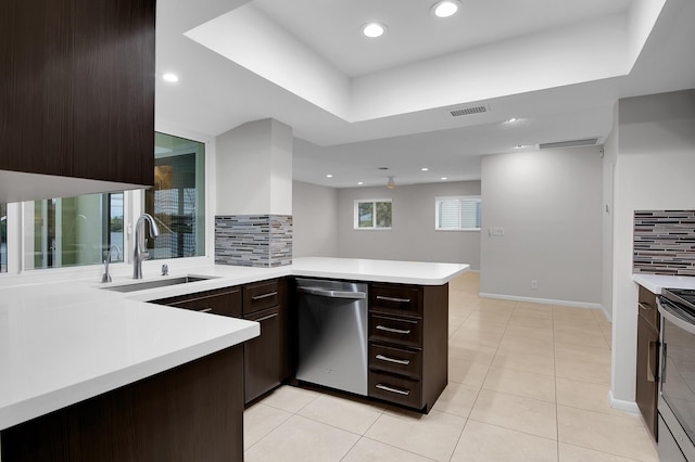 kitchen with a sink, dark brown cabinetry, light countertops, appliances with stainless steel finishes, and visible vents