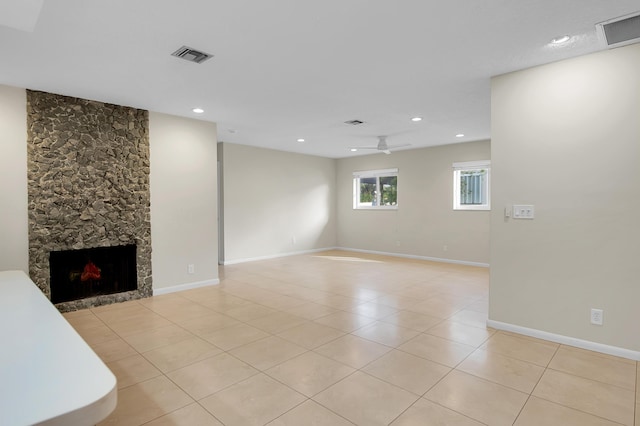 unfurnished living room featuring light tile patterned flooring, visible vents, and ceiling fan