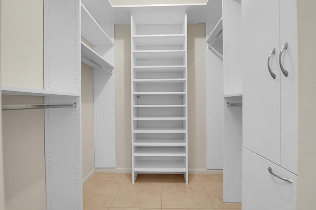 spacious closet with light tile patterned floors