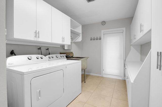 washroom featuring washing machine and clothes dryer, light tile patterned flooring, cabinet space, baseboards, and visible vents