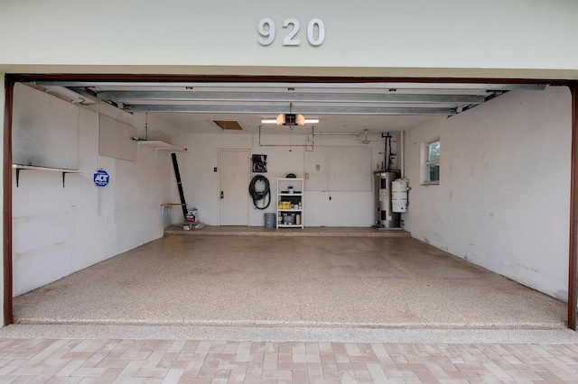 garage featuring a garage door opener and electric water heater