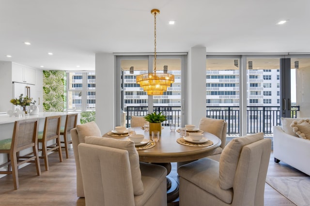 1180 S Ocean Blvd Unit 11D, Boca Raton, FL 33432 - dining area with light wood-style floors, a wall of windows, a chandelier, and recessed lighting