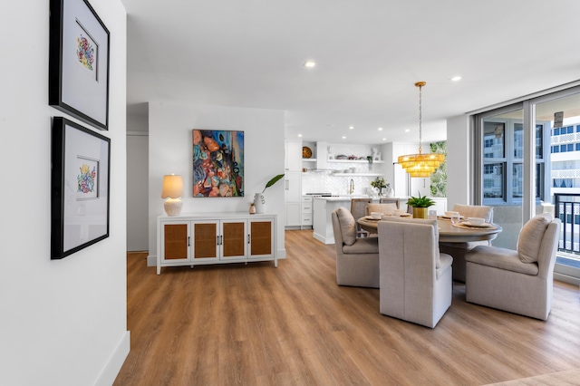 1180 S Ocean Blvd Unit 11D, Boca Raton, FL 33432 - dining room with light wood-style flooring, recessed lighting, a chandelier, and baseboards