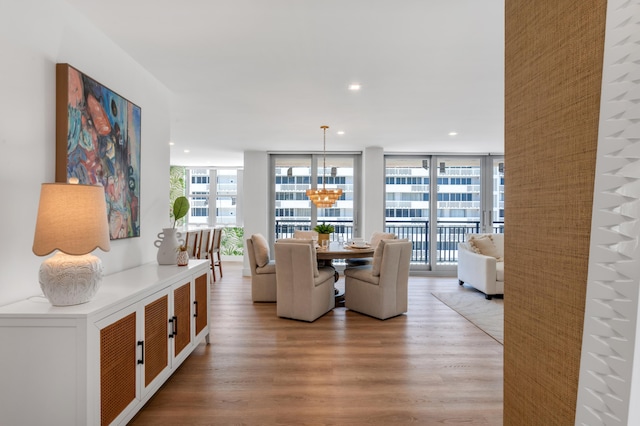 1180 S Ocean Blvd Unit 11D, Boca Raton, FL 33432 - dining room with wood finished floors, a chandelier, recessed lighting, and floor to ceiling windows
