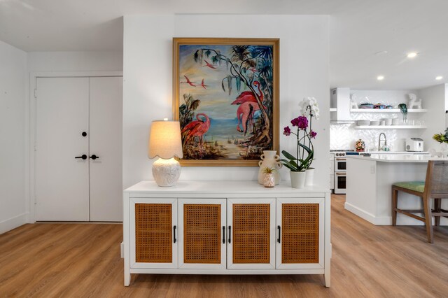1180 S Ocean Blvd Unit 11D, Boca Raton, FL 33432 - detailed view of wood finished floors, a sink, and recessed lighting