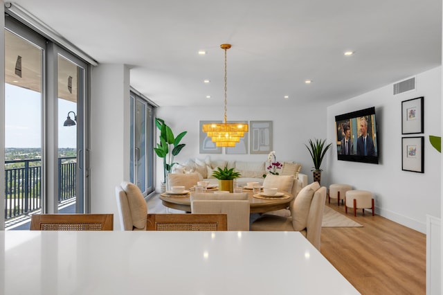 1180 S Ocean Blvd Unit 11D, Boca Raton, FL 33432 - dining area with wood finished floors, recessed lighting, a chandelier, baseboards, and floor to ceiling windows