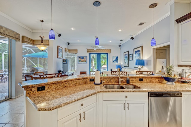 kitchen featuring dishwasher, a ceiling fan, a sink, light stone counters, and hanging light fixtures