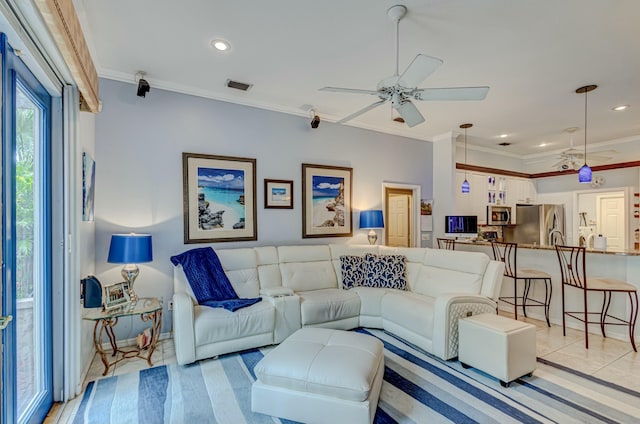 living area featuring crown molding, a ceiling fan, and recessed lighting