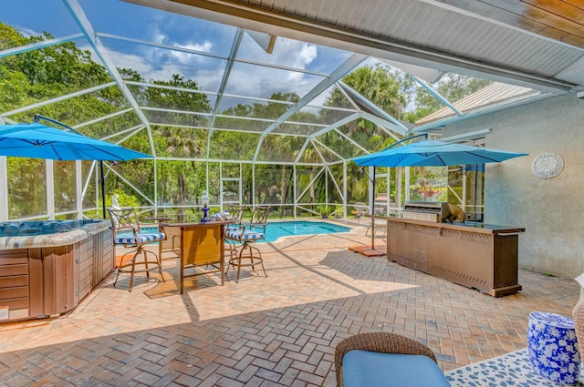 outdoor pool with a hot tub, exterior kitchen, glass enclosure, a patio, and grilling area