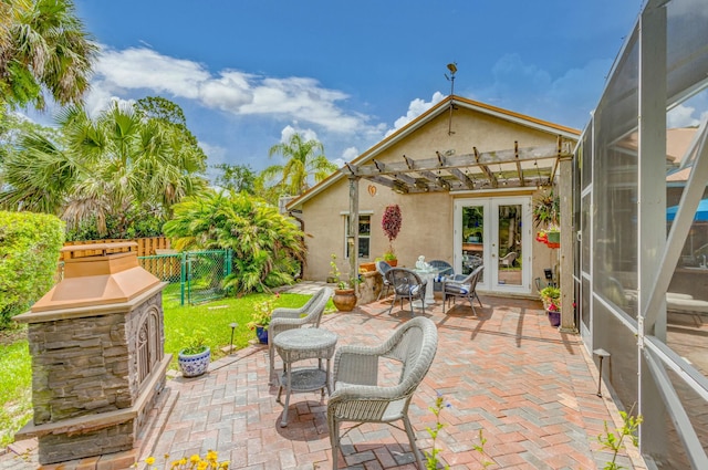 view of patio with fence, a pergola, french doors, and a gate