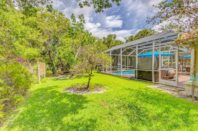view of grassy yard with an outdoor pool and glass enclosure