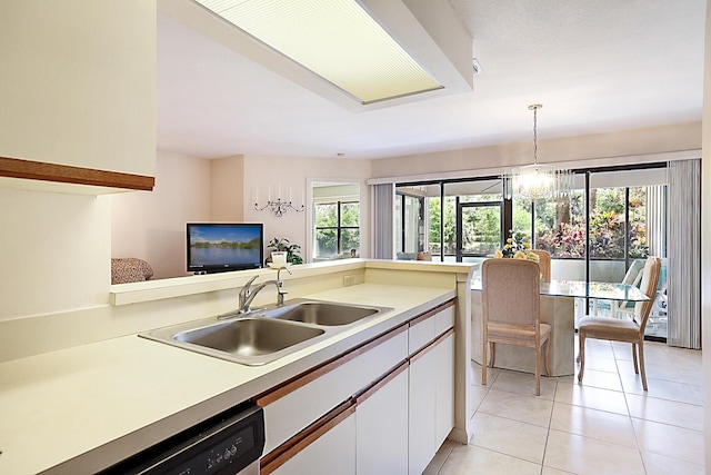 kitchen with light tile patterned floors, white cabinetry, dishwasher, light countertops, and a sink