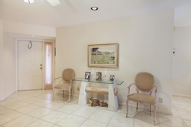 sitting room featuring light tile patterned floors and baseboards