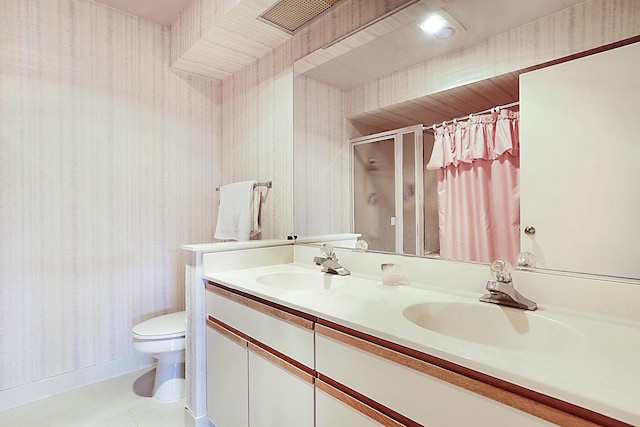 bathroom featuring wallpapered walls, toilet, a sink, and a stall shower