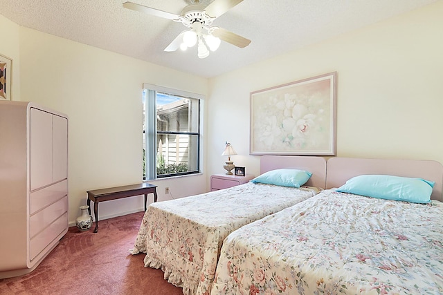 carpeted bedroom with baseboards, a textured ceiling, and a ceiling fan