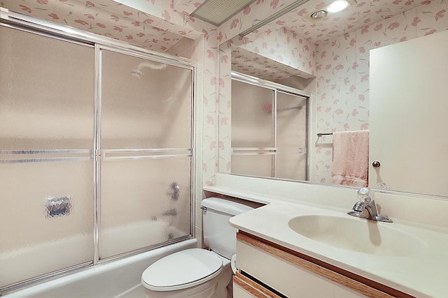 full bathroom with toilet, wallpapered walls, enclosed tub / shower combo, and vanity