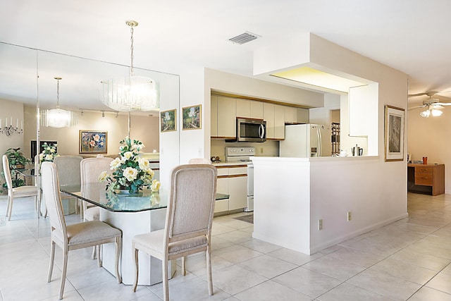 dining space featuring visible vents, an inviting chandelier, and light tile patterned flooring