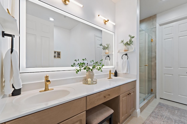 full bathroom with a stall shower, a sink, and tile patterned flooring